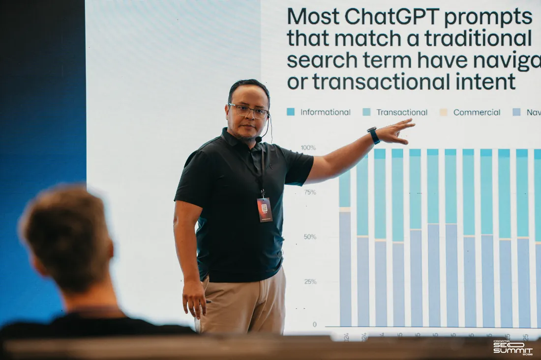Fernando Angulo presenting on stage to a conference audience